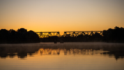 two bridges in sunrise above river