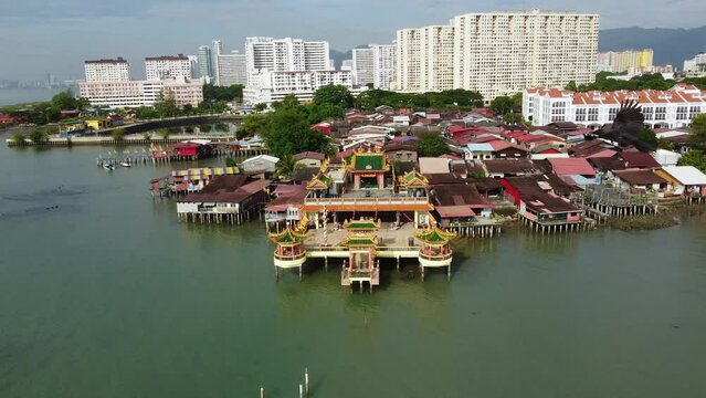 Penang, Malaysia: Aerial drone footage of the Hean Boo Thean Kuan Yin Temple by the Clan jetty in George Town, the colonial historic city in the island of Penang. Shot with a forward tilt down motion.