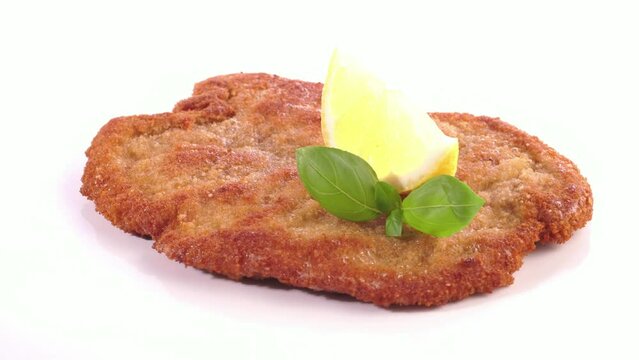 Food Closeup of Breaded Schnitzel with Lemon isolated on white Background