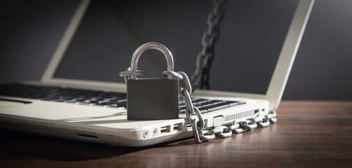 Fototapeta na wymiar Laptop locked with chains and padlock.