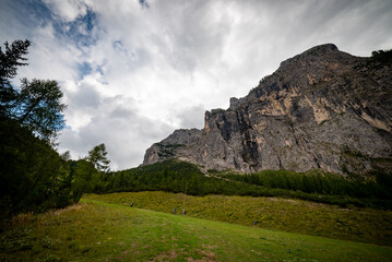 landscape with clouds over the mountains dolomiti monte Civetta, with blue sky and green trees in Italy