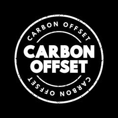 Fototapeta premium Carbon offset - reduction of emissions of carbon dioxide made in order to compensate for emissions made elsewhere, text concept stamp