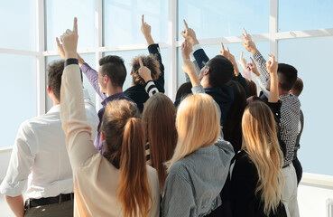 Obraz premium group of diverse young business people pointing in one direction