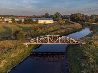 Old steel tram bridge over the Ner River in the city of Lutomiersk, Poland.