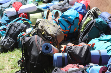 backpacks and backpacks with sleeping bags during the boyscout summer camp without people - obrazy, fototapety, plakaty