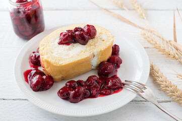 Cherry dessert with a delicious swiss roll and sour cherry compote