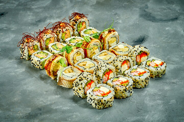 Set of sushi rolls with different fillings on a gray background. Selective Focus. Noise graine add...