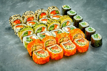 Set of sushi rolls with different fillings on a gray background. Selective Focus. Noise graine add on post