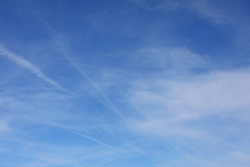 sky and clouds and white chemtrails of dubious origin