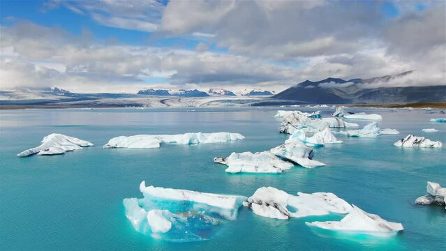 aerial view drone of the iceberg floating on water at the glacier lagoon lake jokulsarlon iceland,drifting icebergs in the sea,vatnajokull national park sunny day