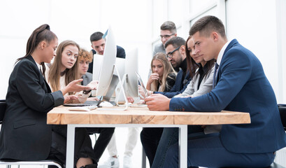 group of employees discussing the information coming into the office
