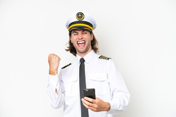 handsome Airplane pilot isolated on white background with phone in victory position