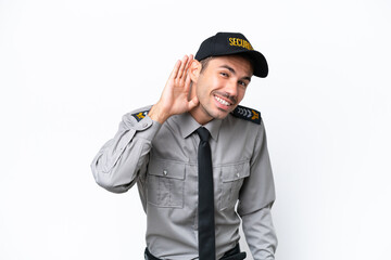 Young safeguard man over isolated white background listening to something by putting hand on the ear