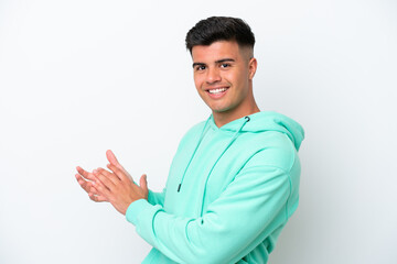 Young caucasian handsome man isolated on white background applauding