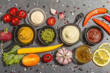 Set of sauces and fresh vegetables. Ketchup, mustard, mayonnaise, wasabi, sweet curry, and BBQ