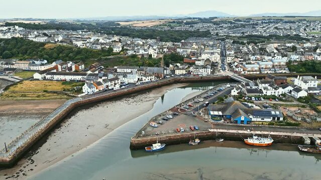 Aerial Video of the small English fishing village of Maryport in Allerdale a borough of Cumbria, England.
Shot using a drone and looking down onto the harbour, boats, and surrounding town.