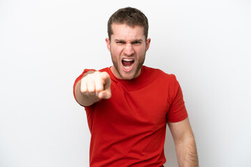 Young caucasian man isolated on white background frustrated and pointing to the front