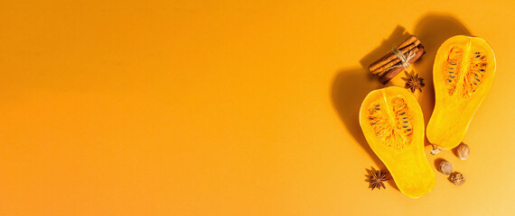 Halves of the butternut pumpkin with spices. Traditional autumn ingredients for cooking