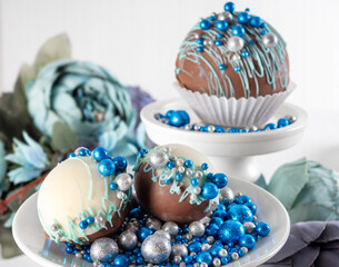 Dessert chocolate bombs with marshmallows in decorative design