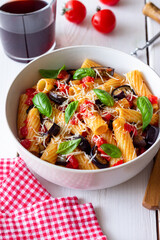 Pasta alla Norma with eggplant, tomatoes, cheese and basil. Italian food. Vegetarian food.