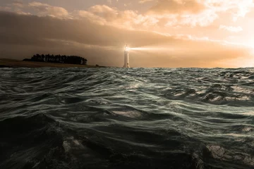 Tuinposter Vuurtoren Stormy sea with lighthouse