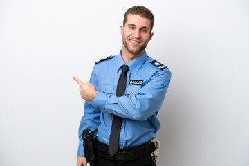 Young police caucasian man isolated on white background pointing back