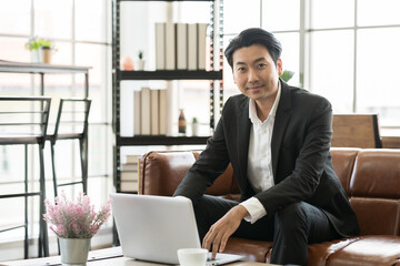 Asian business man wear suit at the office. Smiling Asian business man working in the office