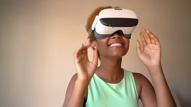 Excited surprised Black woman testing wearing virtual reality simulator headset home. Happy positive emotions. green clothes. touches glasses with hands. Video footage green clothes beige background