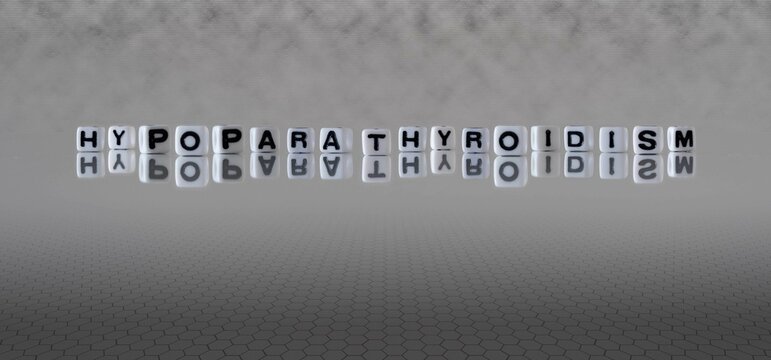 hypoparathyroidism word or concept represented by black and white letter cubes on a grey horizon background stretching to infinity
