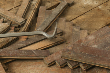 Home improvement. Removing old wooden parquet flooring using crowbar tool. Old wooden floor renovation.	