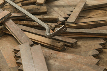Home improvement. Removing old wooden parquet flooring using crowbar tool. Old wooden floor...