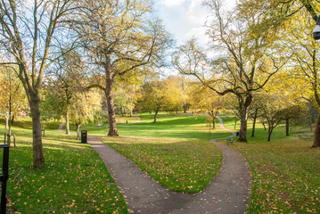 View of the Winckley Square gardens public park with the forking walking path in autumn in Preston, Lancashire, England, UK