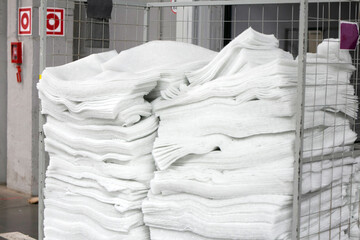White foam rubber rolls. Textured foam materials. Rolled soft protection material for building