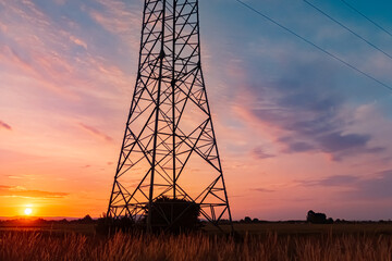 Beautiful sunset with a dramatic sky and overland high voltage lines near Tabertshausen, Bavaria,...