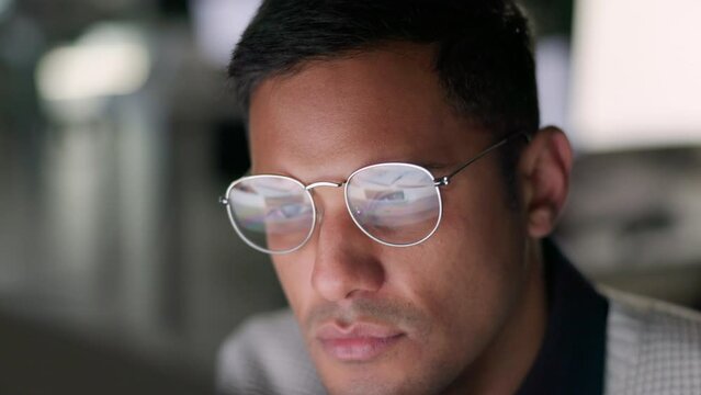 Focus, working and business man from Guatemala with a computer screen reflection on glasses. Corporate businessman face busy with digital planning, tech work and internet web strategy online at work