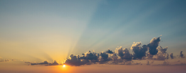 Sunset sky with cloud and sunrays.