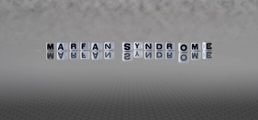 marfan syndrome word or concept represented by black and white letter cubes on a grey horizon background stretching to infinity