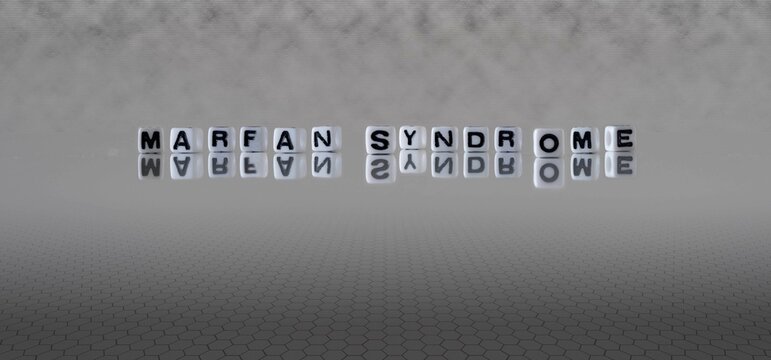 marfan syndrome word or concept represented by black and white letter cubes on a grey horizon background stretching to infinity