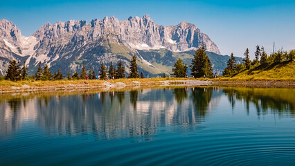 Beautiful alpine summer view with reflections in a lake at the famous Astberg summit, Going, Wilder Kaiser, Tyrol, Austria