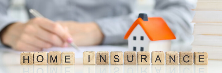 Agent fills out a home insurance form closeup