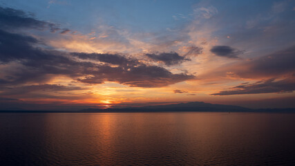 Fototapeta na wymiar Colourful sunset over the sea at Greek island Thassos