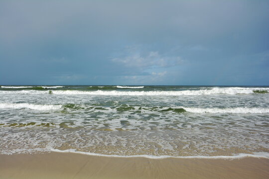 Beautiful coast of the Baltic Sea in Poland. Endless sandy beach, sea water waves.