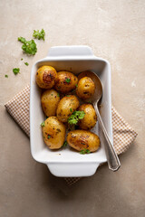 Roasted potatoes with herbs, homemade cookig. Lifestyle food, top view.