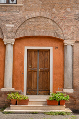 Fototapeta na wymiar Beautiful carved wooden antique vintage doors on the street in trastevere area