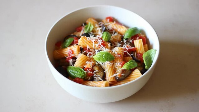 Pasta alla Norma with eggplant, tomatoes, cheese and basil. Italian food. Vegetarian food.