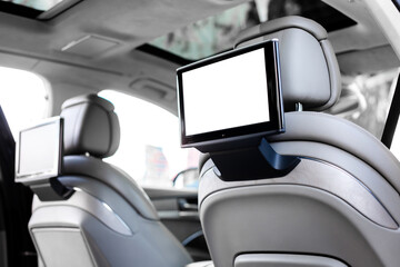 Modern luxury car interior with empty white touchscreen monitor with copy space.