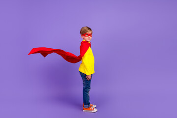 Full length photo of funny funky small son wear red mantle wind blowing isolated violet color...