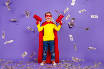 Full length photo of cool impressed little grandson dressed red cape shooting cash flying isolated...