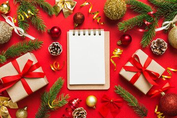 Christmas blank greeting card mock-up scene. Creative layout made of Christmas tree branches and paper card note. Flat lay. Nature New Year concept