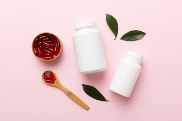 different drugs and health supplement pills with medicine bottle health care and medical top view. Vitamin tablets. Bottle with colored pills on table background. Multivitamins